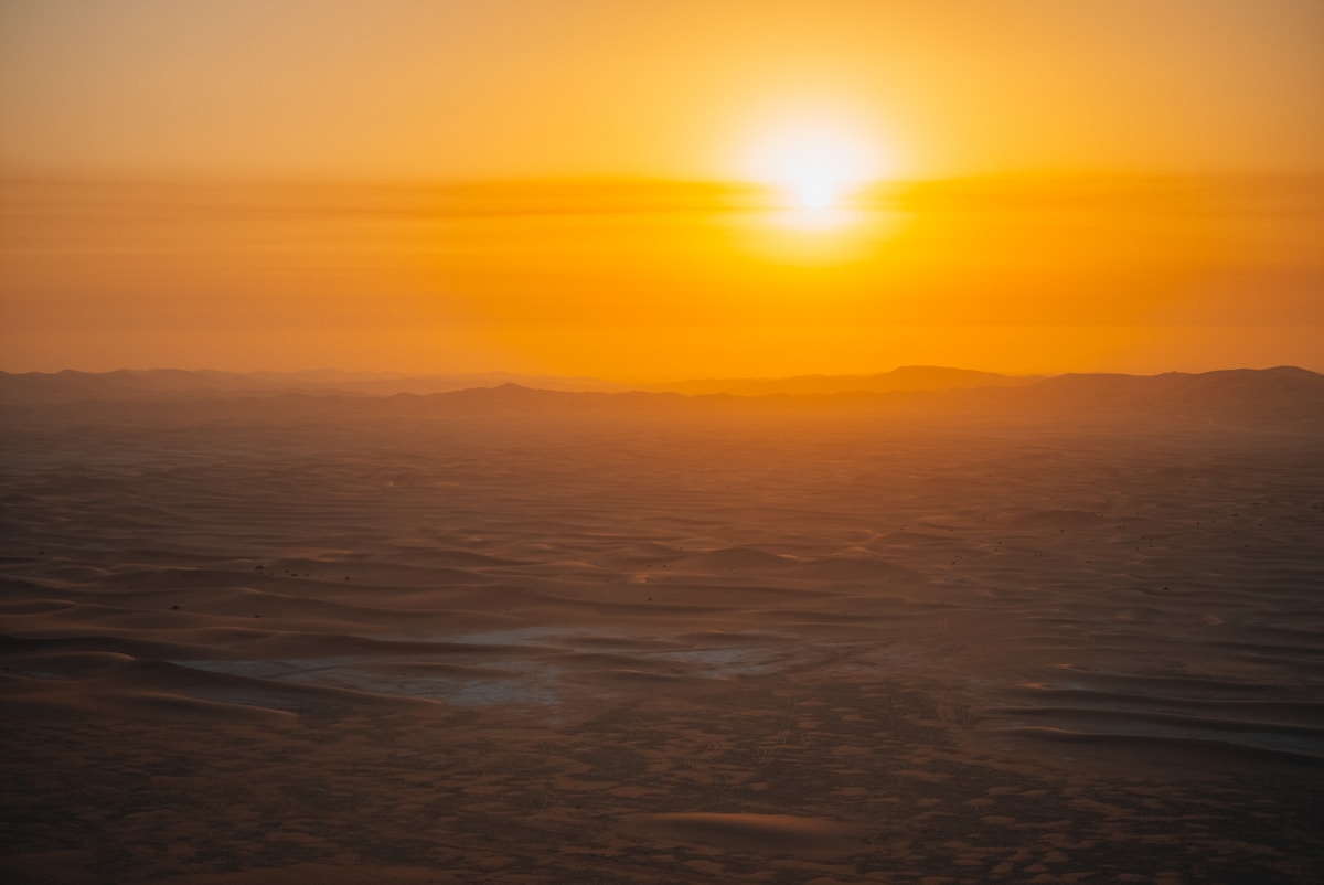 Warm golden sunset over Arabian desert dunes