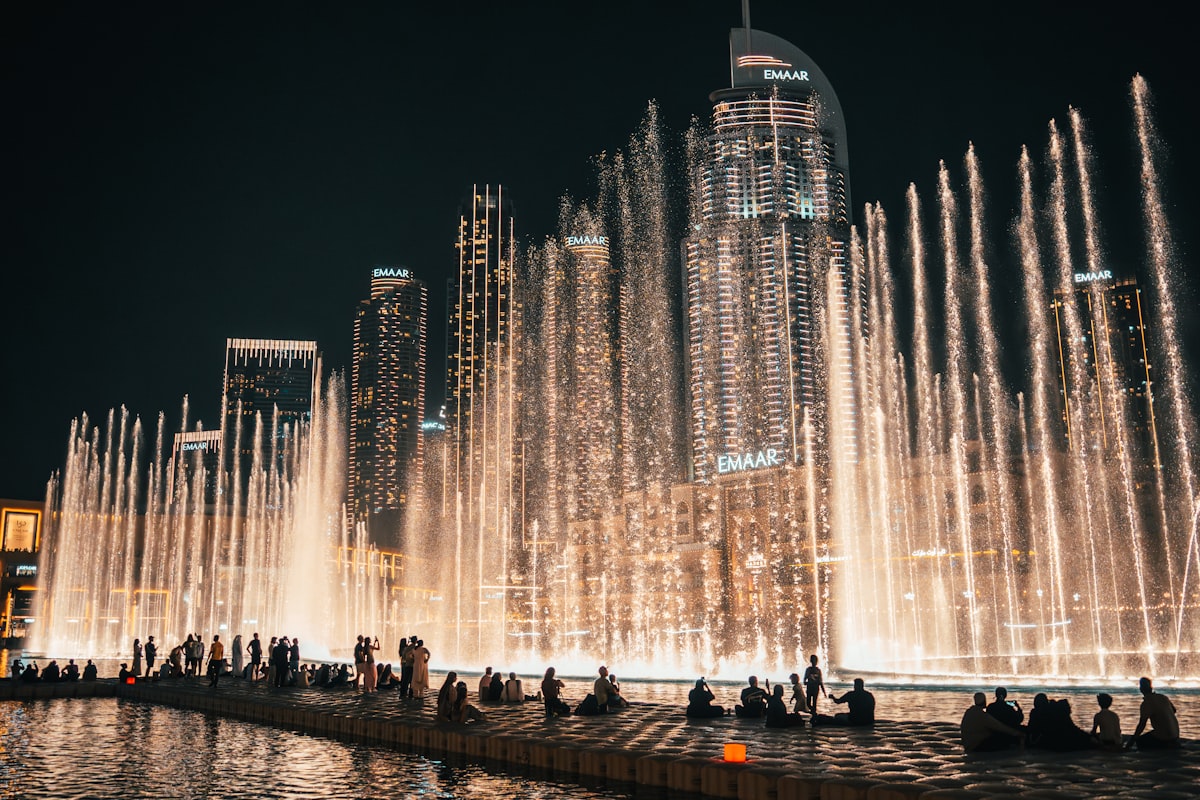 Dubai Fountain water show at night with illuminated EMAAR towers