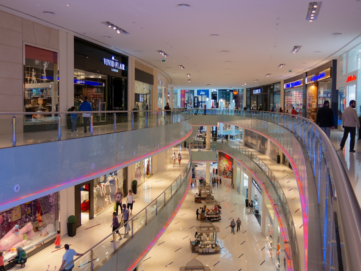 Multi-level shopping mall interior viewed from above with shoppers